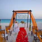 A destination wedding ceremony set up on the beach.