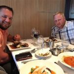 Two men enjoying a meal on the Royal Car