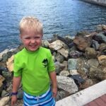 A young boy in a green shirt enjoying