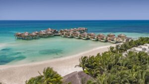 An aerial view of a beach resort with Karisma Overwater Bungalows.