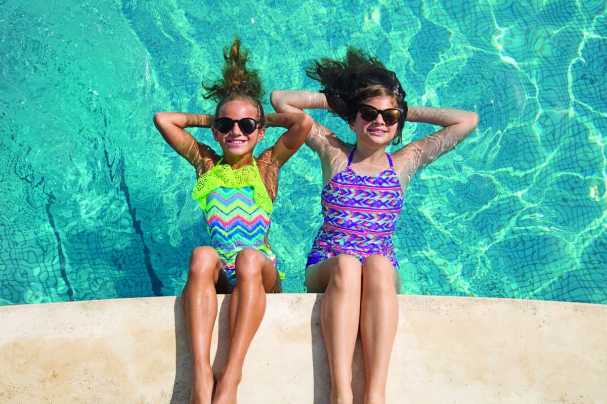 Two girls enjoying a pool at Nickelodeon Resort in their swimsuits. Two girls enjoying a pool at Nickelodeon Resort in their swimsuits.