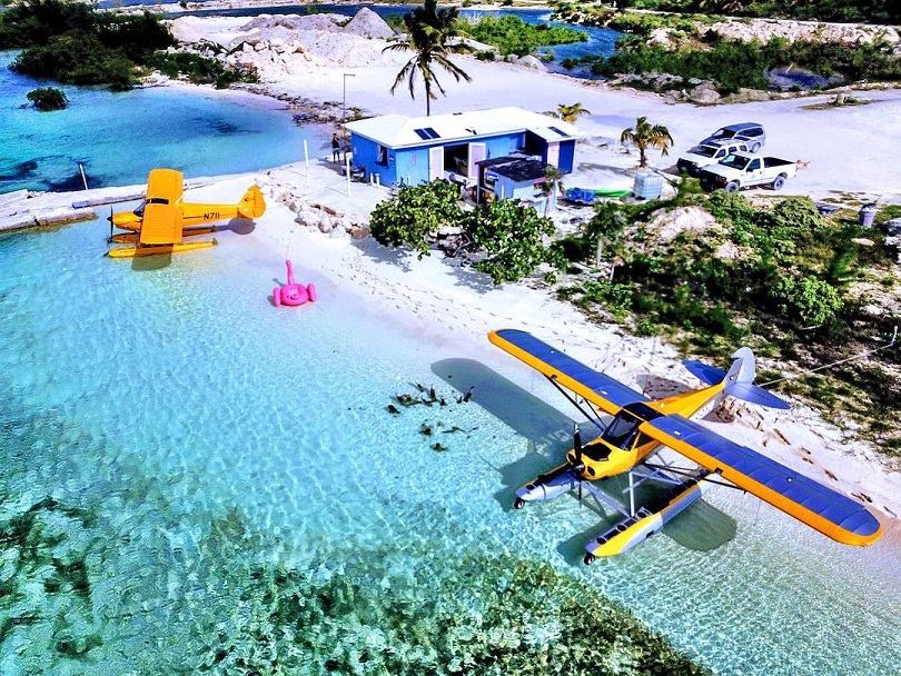 A small plane sits on the Caribbean beach. A small plane sits on the Caribbean beach.