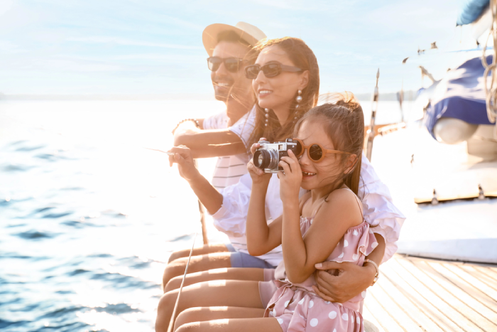 Happy young family resting on yacht